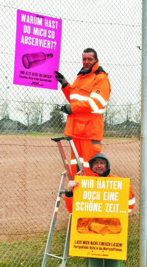Das Foto zeigt Mitarbeiter des Baubetriebshofes, die Plakate zu der Aktion aufhängen